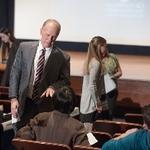 Doctor Potteiger speaking to someone in the audience of the 3MT Competition